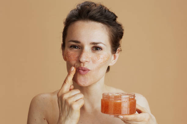 istock modern woman with face scrub on beige background 2025971839