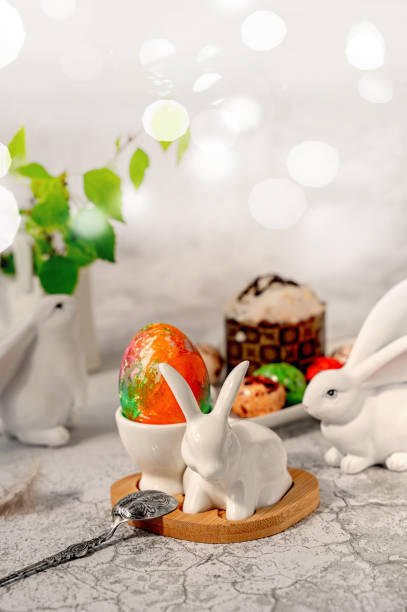 Happy Easter, Easter painted egg in the shape of a bunny shaped egg cup on the table. Stylish holiday table decor. Naturally dyed Easter eggs and spring flowers. Happy Easter, Easter painted egg in the shape of a bunny shaped egg cup on the table. Stylish holiday table decor. Naturally dyed Easter eggs and spring flowers. Copy space. cup shaped flower stock pictures, royalty-free photos & images