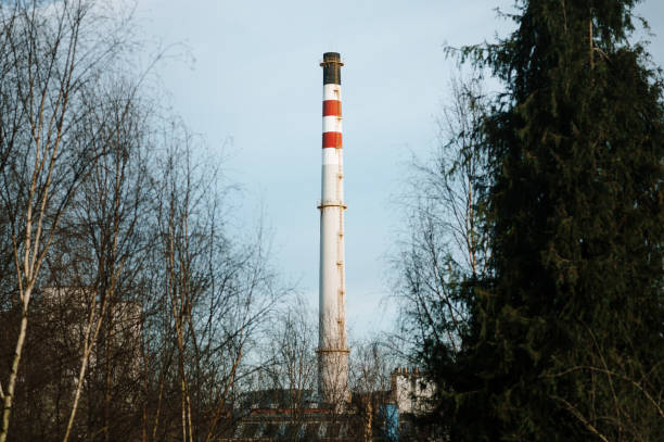 A large factory chimney and trees