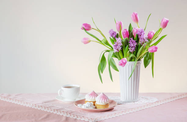 istock cup of tea and cupcakes with spring flowers in light colors 2026019307
