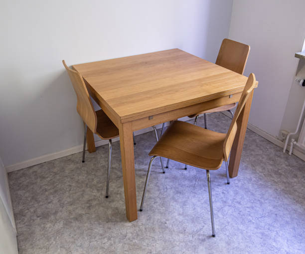 istock Three chairs and a wooden table in a kitchen. 2026043289