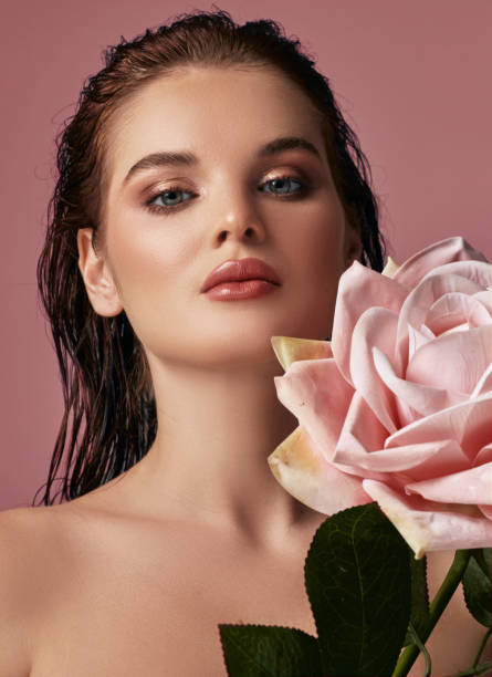 istock A beautiful woman holding a big rose in her lap. 2026052963