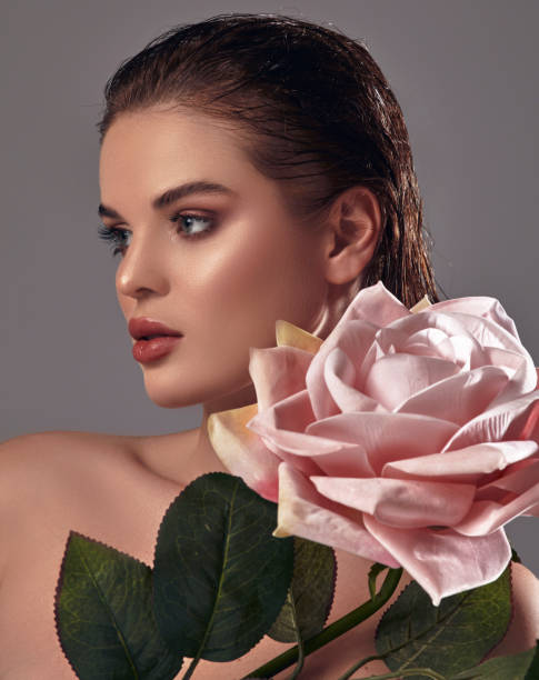 istock A beautiful woman holding a big rose in her lap. 2026054710
