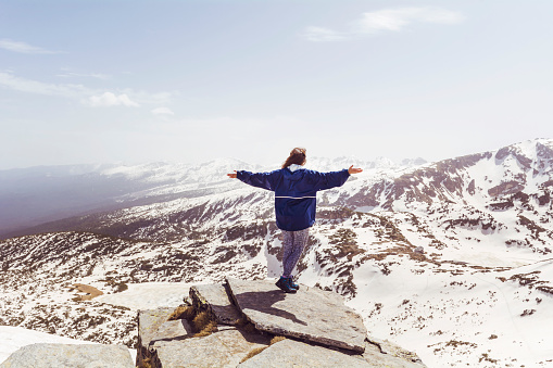 Traveler  Woman  in the winter  mountain . Rila , Bulgaria