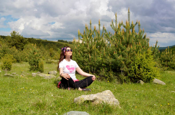 Mature Woman sitting  in the summer  mountain .
