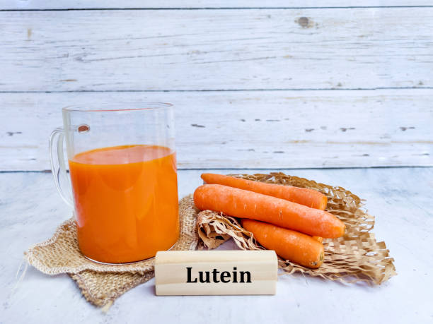 istock Carrot juice in glass and fresh carrots 2026137085