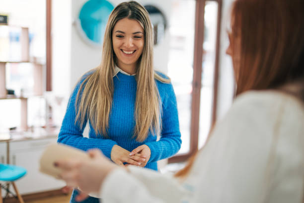 istock Woman choosing eyeglasses frames in a modern optical store. 2026165189