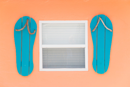 Window with flip flop shutters on a house in southwest Florida, USA.