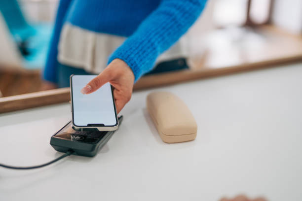 istock woman making a contactless transaction using her smartphone, digital payments concept 2026181870