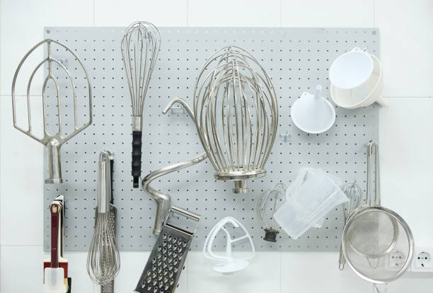 Set of various utensils hanging on wall