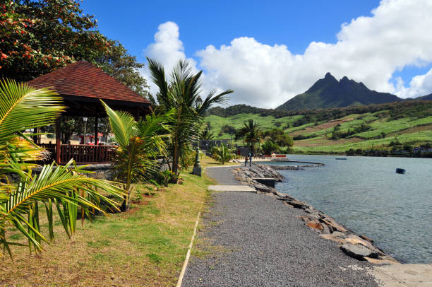 Petit Sable, Grand Port District, Mauritius: the sharp peaks of Bamboo Mountain (Montagne Bambous) seen from the waterfront leisure area, by the bay.