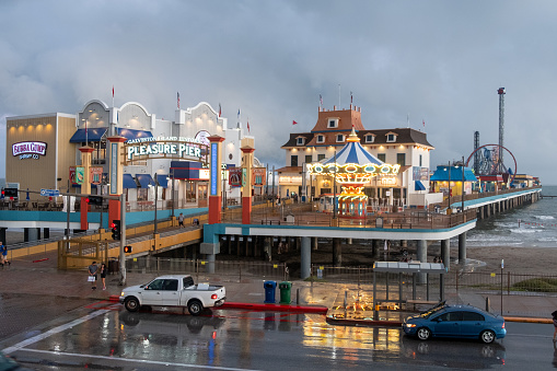 Galveston, USA - October 29, 2023: Pleasure Pier seen from the water in Galveston Island by bad weather conditions., Texas, USA.