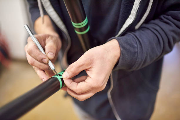 istock Man preparing a bike frame for a custom painting design using a scalpel and tape 2026344536