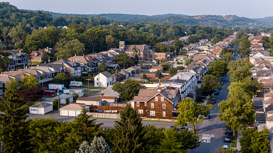 Tree lined community with houses and church line the Delaware Ave in Palmerton, PA