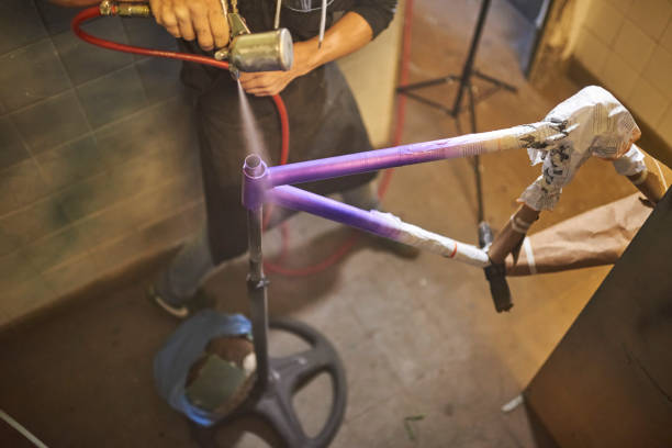 istock Unrecognizable man spray painting a bicycle frame in his workshop. 2026383654