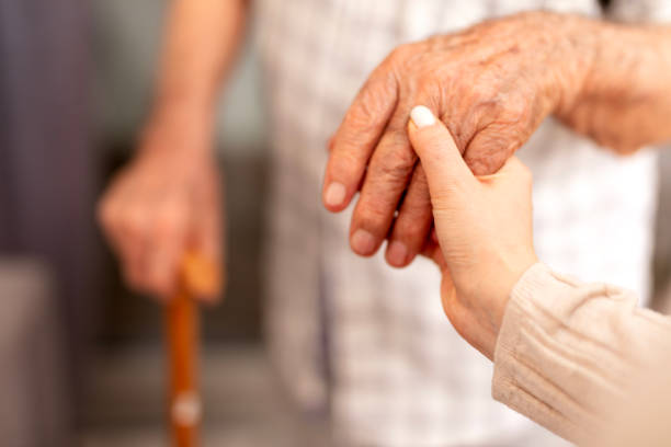 istock Nurse assisting senior with walking cane 2026401481