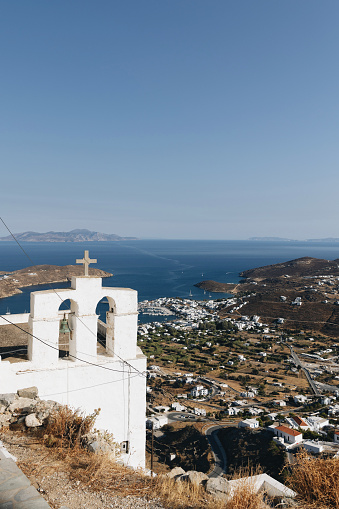 Cycladic white church on a peak overlooking the port town of Livadi in Serifos, Cyclades, Greece