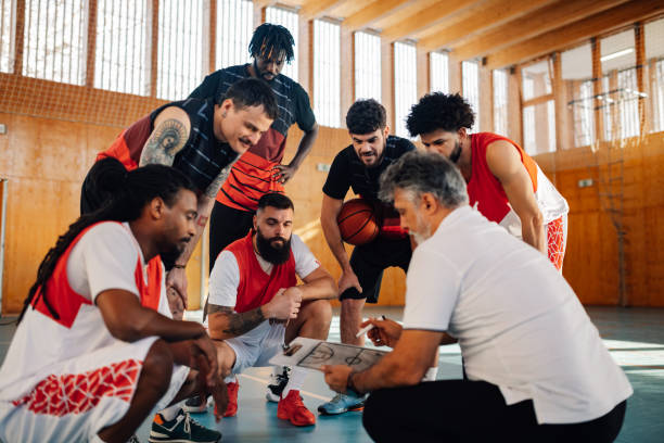 istock Basketball coach working on game plan with his interracial team. 2026408122
