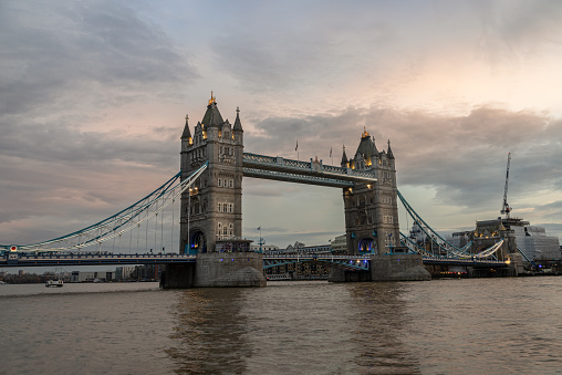 London, UK - Feb 15, 2024 - Scenery view of famous Tower bridge and skyline in the river thames at evening. Copy space, Selective focus.