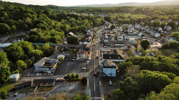 istock Driving on sunny tree covered Main Street: tree lined historical residential area of Walnutport, PA 2026419117