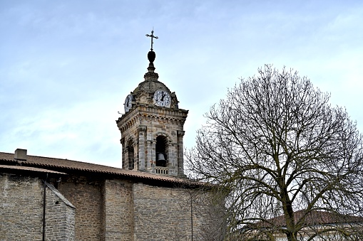 Panoramic view of the typical alsatian village Wihr-au-Val with rooftops, church and hills in the background.