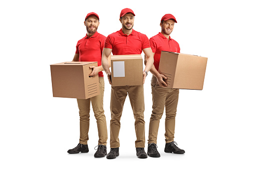 Delivery men with packages in red t-shirts isolated on white background