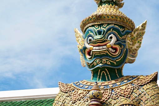 Close-up of Thotsakan, one of two giant statues - characters from the Ramakien epic - guarding the rear Koei Sadet Gate of the Wat Phra Kaew or Temple of the Emerald Buddha at the Grand Palace in Bangkok, Thailand