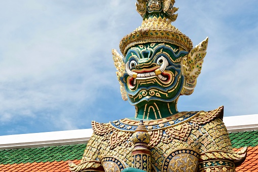 Close-up of Thotsakan, one of two giant statues - characters from the Ramakien epic - guarding the rear Koei Sadet Gate of the Wat Phra Kaew or Temple of the Emerald Buddha at the Grand Palace in Bangkok, Thailand