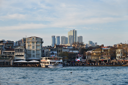 Istanbul, Turkey - December 10, 2023: Cityscape of the city of Istanbul, Bosphorus, city quay and Torun Center at sunset