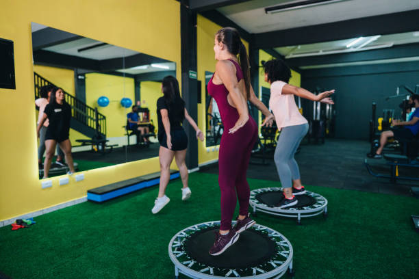 Women exercising on trampoline in a exercise class at the gym
