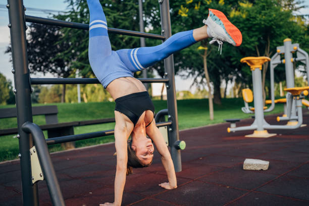 istock Fit young woman doing handstand 2026550566