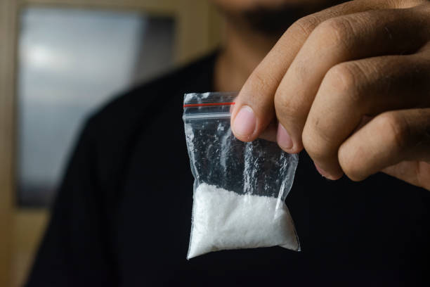 man holding drugs illustration of man hand holding drugs. concept of a man addicted to drugs. stop drugs cocaine stock pictures, royalty-free photos & images