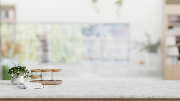 istock Seasoning bottle, a potted plant, and empty space on a tabletop in a modern white kitchen. 2026602802