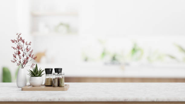 istock Seasoning bottle, flower vases, and empty space on a tabletop in a modern white kitchen. 2026602806