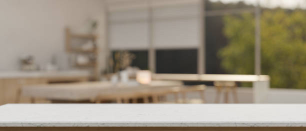 istock Empty space on a white tabletop with a blurred background of a modern kitchen with a dining table. 2026607543