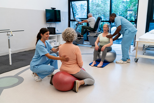 Group of senior patients working out during physiotherapy with the guidance of the therapists - Healthcare concepts