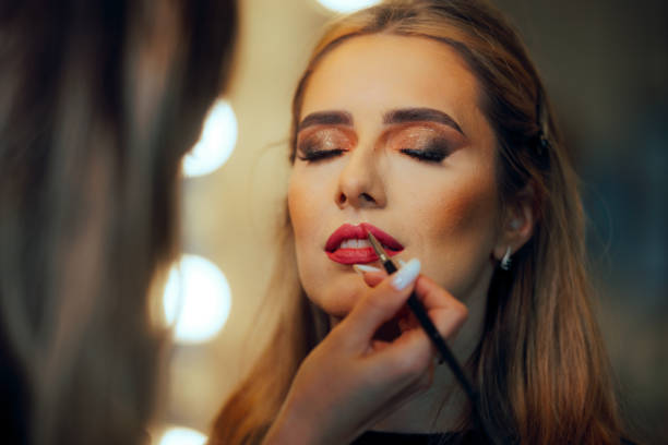 istock Professional Makeup Artist Applying Lipstick on the Client 2026634293