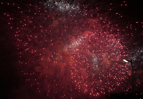 Red burning fireworks in sky