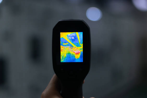 Professional Electrician use thermal infrared camera or thermometer scanning electrical system for preventive maintenance,Industrial thermography,Thermal image of power electric.