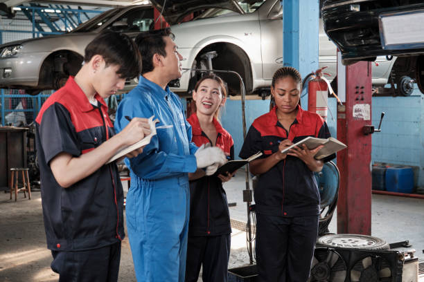istock A supervisor engineer is training mechanic workers about car repair at a garage. 2026686527
