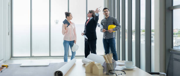istock Engineer team meeting to inspect the construction blueprint drawings, work plan and distribute work before starting the building 2026696309