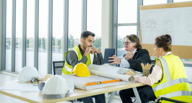 istock Engineer team is meeting to inspect the construction blueprint drawings, work plan and distribute work before starting the building 2026696327