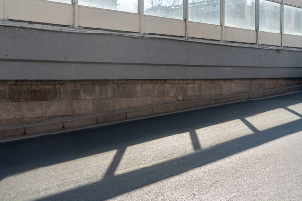 empty asphalt road in downtown of modern city during daytime. copy space for parking lot.