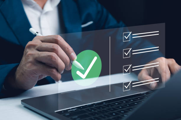 istock A professional's hands interact with a virtual checklist on a transparent screen over a laptop, symbolizing efficient task management and digital progress. Business performance checklist. 2026707717