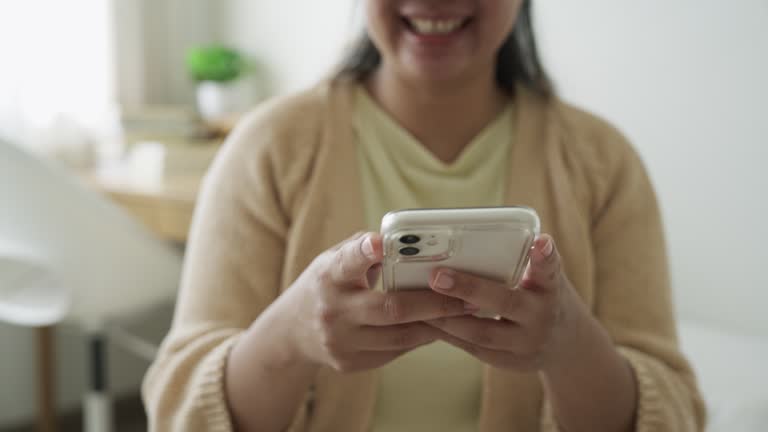 Woman typing or texting message chat with friends using a mobile phone