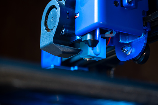 Close-up detail of the extruder of a 3D printer