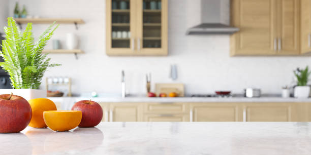 Wooden kitchen interior background with focus on the white table in the kitchen and blurred background. 3d rendering