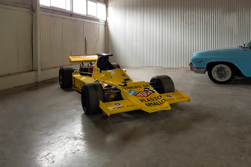 Avellaneda, Argentina - May 6, 2023: Old yellow 1970s Meifa Chevrolet Argentine mechanics Formula 1 racecar in a garage at a classic car show.
