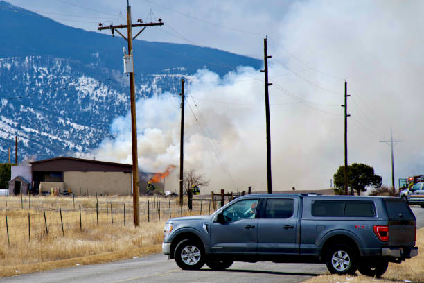 Poncha Springs, Colorado, USA - February 10, 2024: Firefighters battle a structure fire in the distance that quickly erupted on a cold, winter afternoon.
