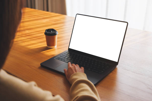 istock Mockup image of a woman working and typing on laptop computer with blank white desktop screen at home 2026810874